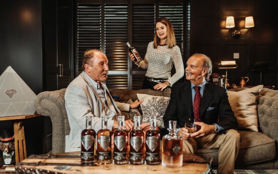 Charles MacLean sampling the XOP 75th Anniversay whiskies with Fred and Cara Laing.