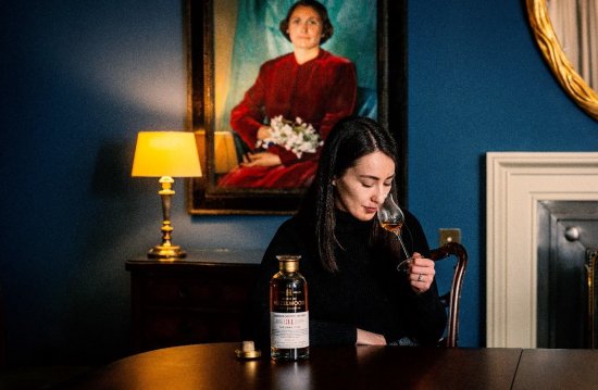 Eilidh Muir, nosing The Long View whisky she blended in front of a portrait of Janet Sheed-Roberts (Credit: John Paul Photography) Eilidh Muir, nosing The Long View whisky she blended in front of a portrait of Janet Sheed-Roberts (Credit: John Paul Photography)