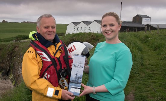 RNLI Lifeboatcrew Graham Campbell and Nicola Stevenson, Scapa Distillery Visitor Manager present Scapa Jutland.